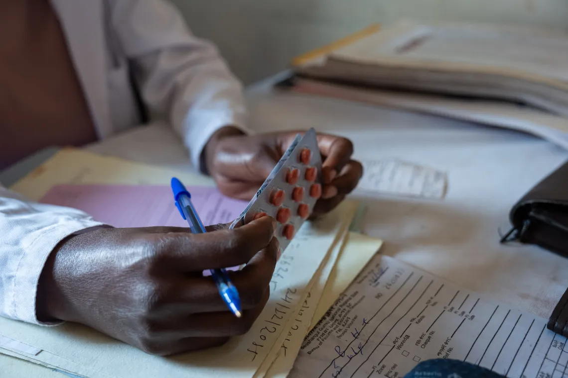 A health worker holding micronutrient supplementation 