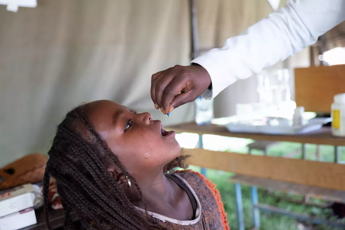 A little girl receiving vitamin A supplement. 