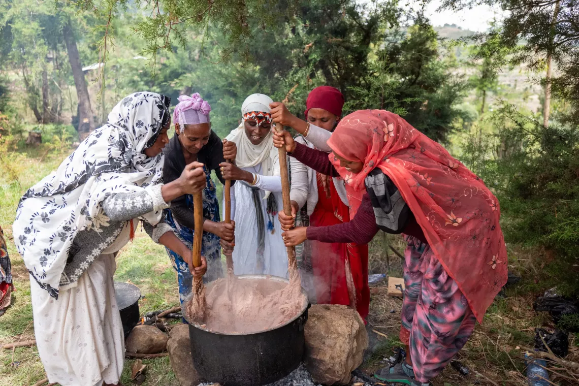 Group of health workers mixing and making nutritious porridge. 