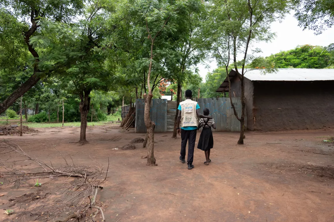 A man walking with a young girl
