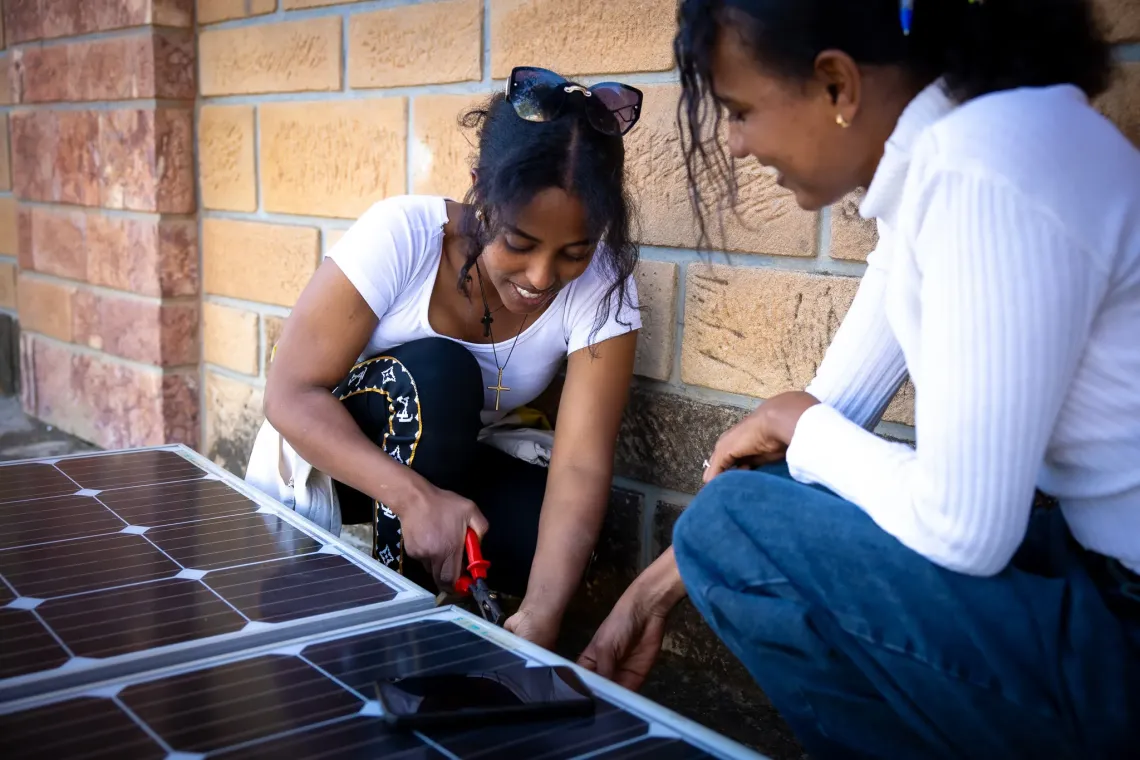 Saron, 24, participant of Biqu Wetat Programme fixing a solar panel.