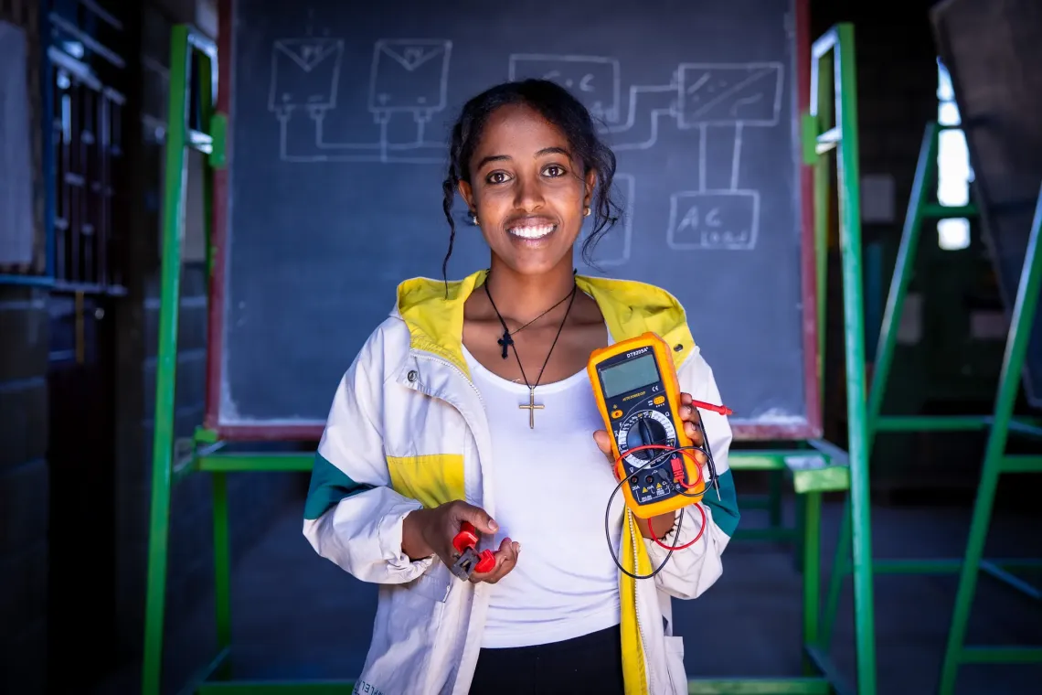 Saron,24, partipant of the Biqu Wetat Programme demonstrating solar equipment.