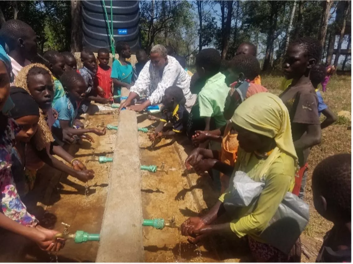 Children washing their hands using the UNICEF-supported handwashing facility