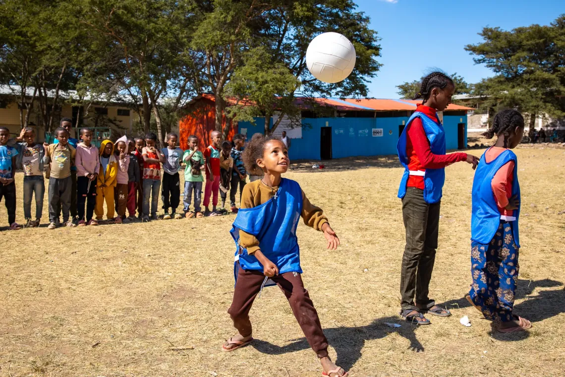 Adiam playing volleyball with her classmates. 