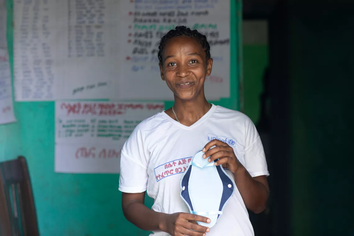Workalem pauses for a photo holding a sanitary pad