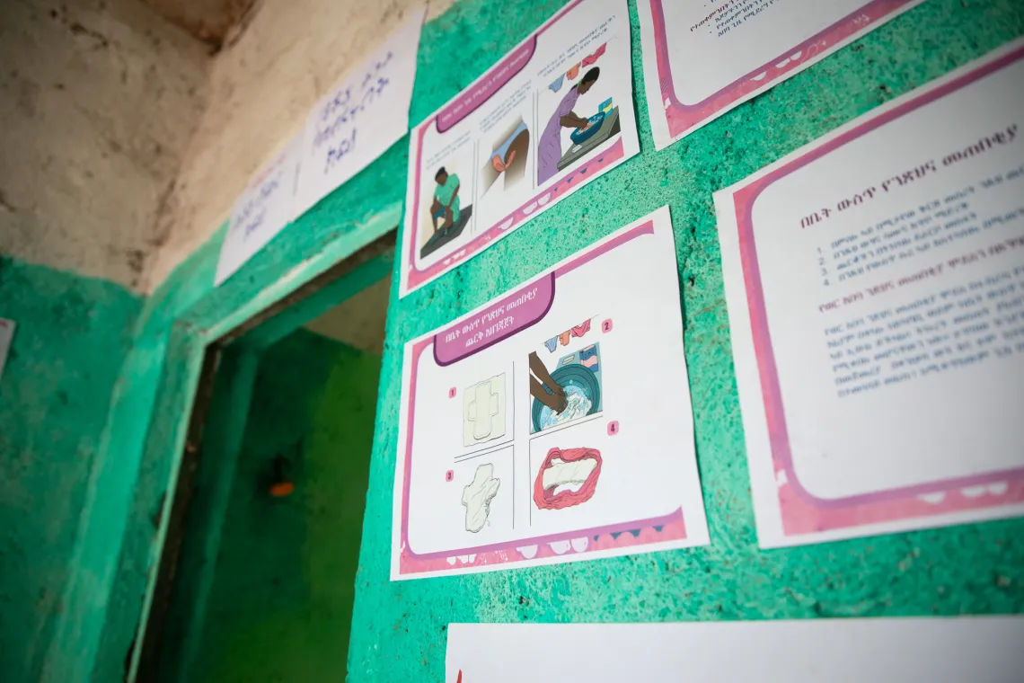 Workalem stands in a room with mattresses laid on her left and right side. The room is where girls rest during their period. 