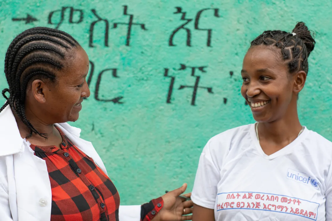 Aster talking to Workalem in front of the menstrual hygiene and health facility