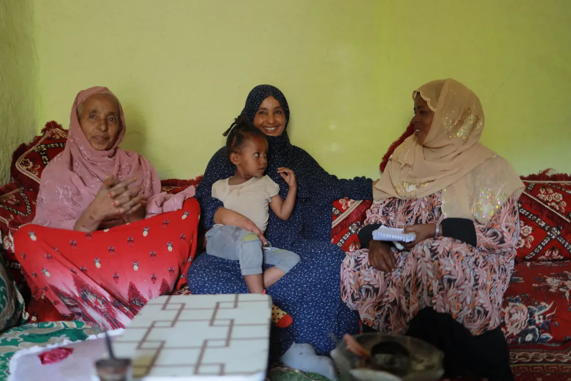 A health extension worker sitting with mothers