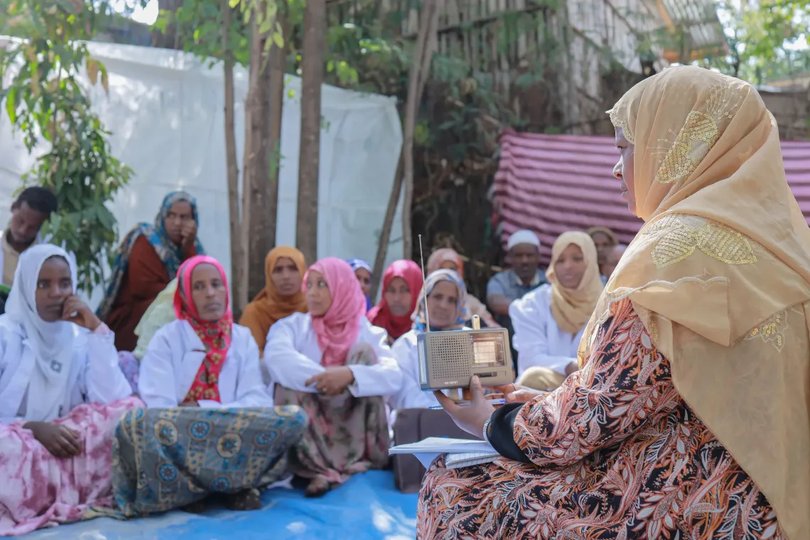 A health worker leading a community discussion