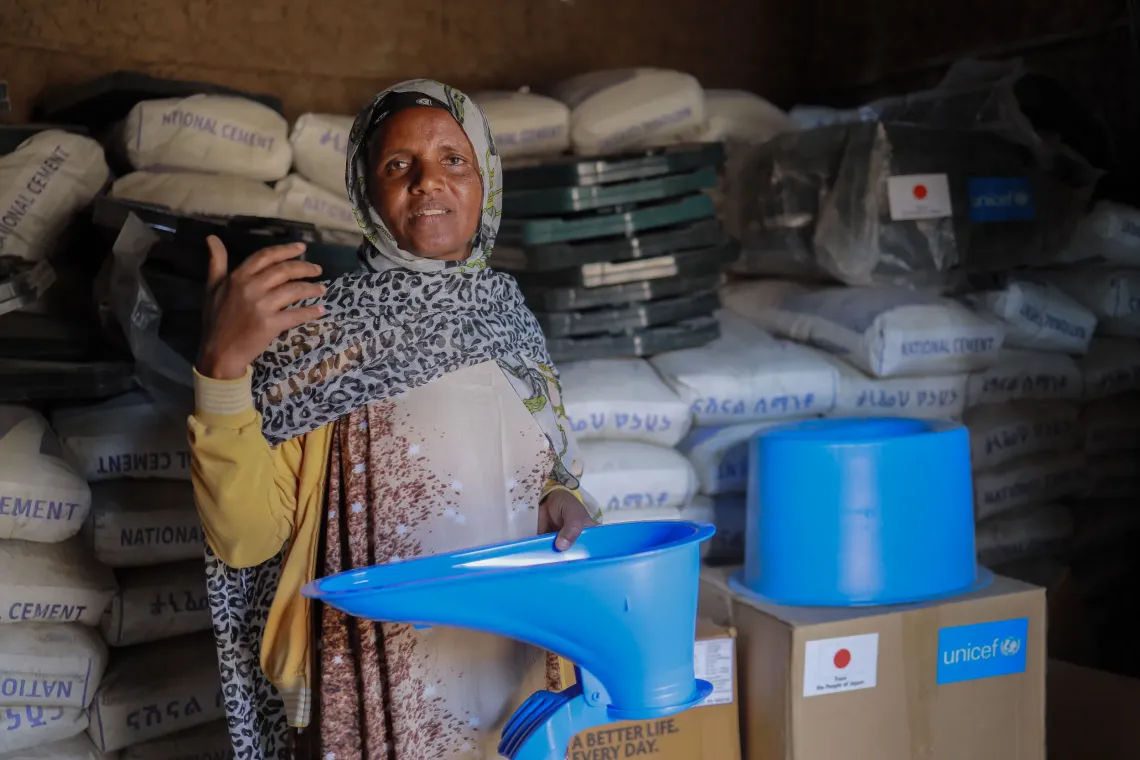 A women holding an improved latrine in her hand