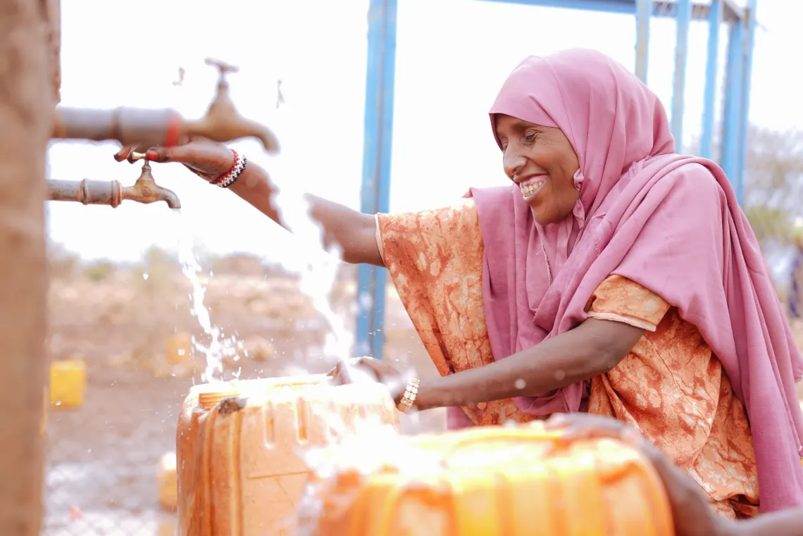 A women fetching water form nearby water system