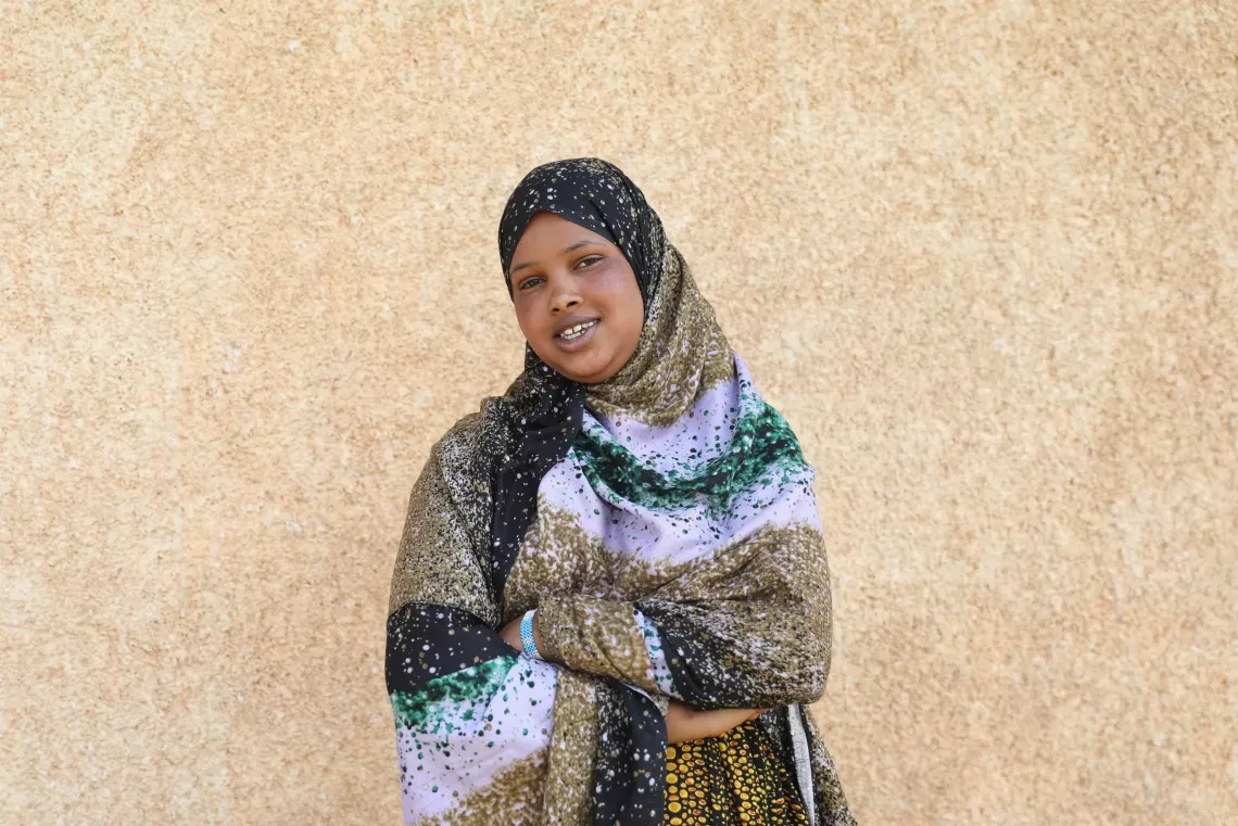 A young girl wearing hijab posing for a photo