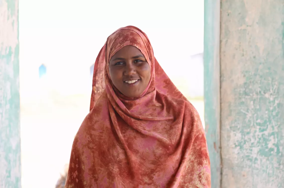 A young girl wearing hijab posing for a photo