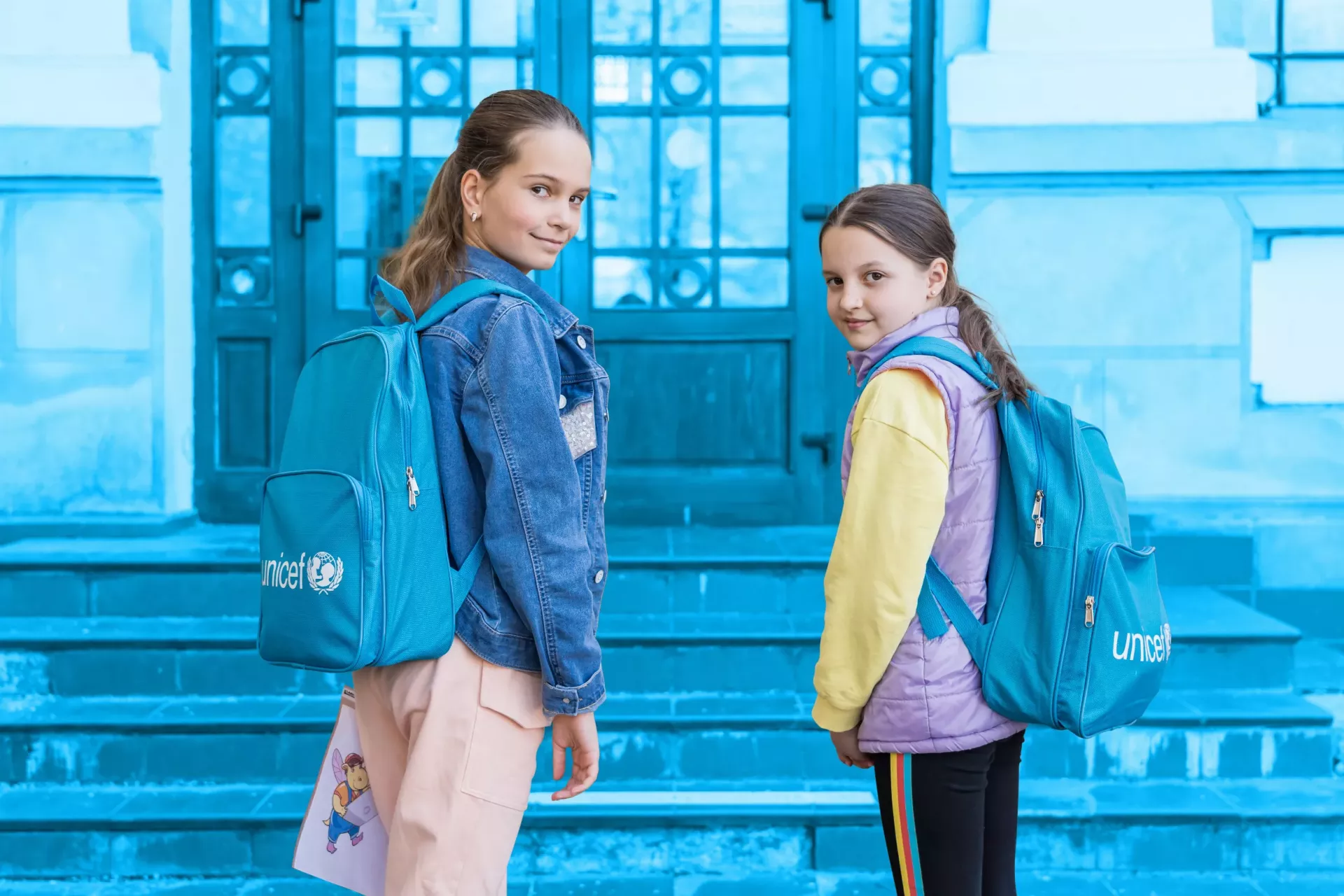 Two girls with UNICEF school backpacks