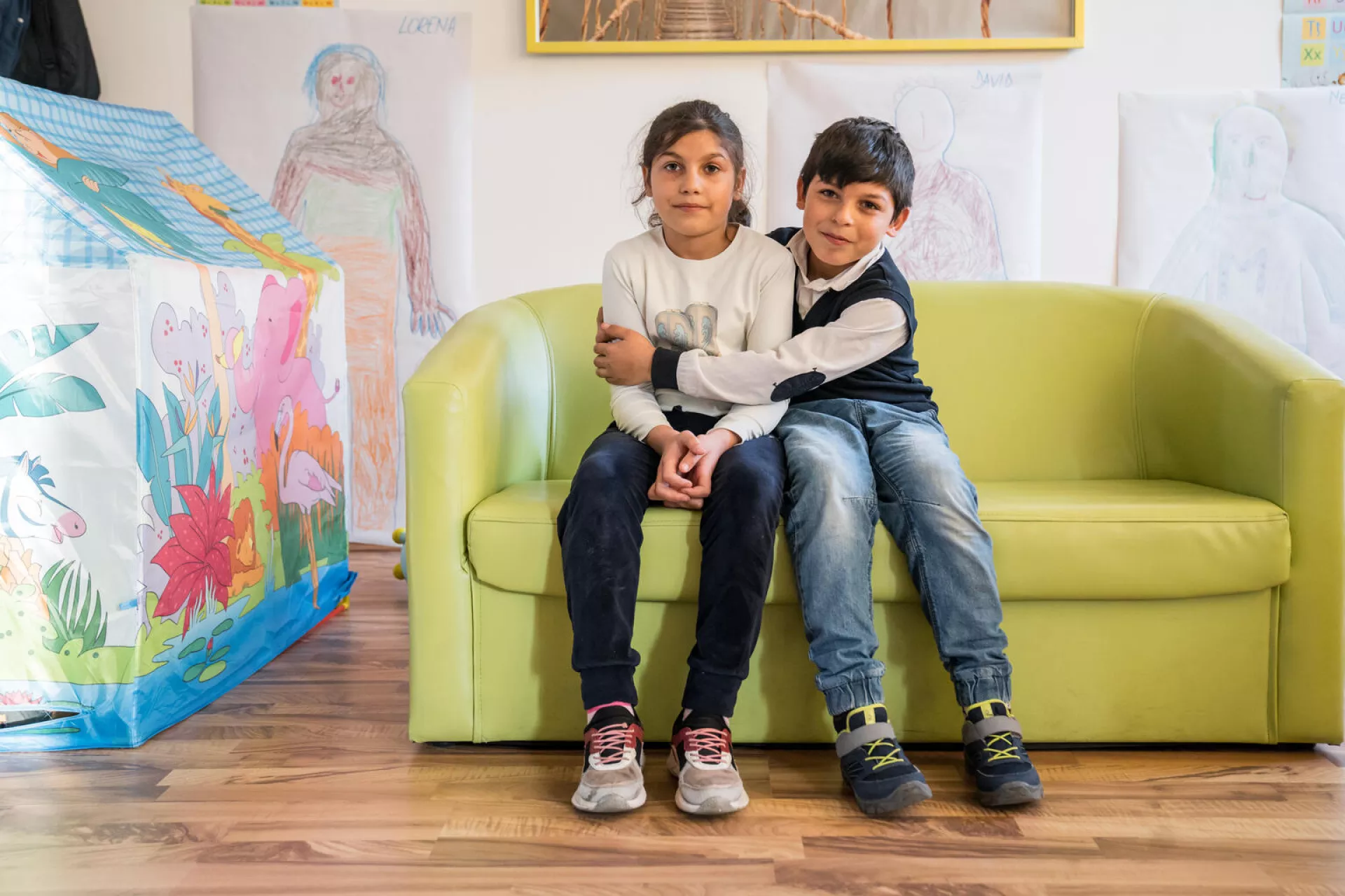 Brașov Romania, 3 November 2022 - Loredan (10) hugs his sister Lorena (9) in the Integrated Community Center in Brașov, Romania.