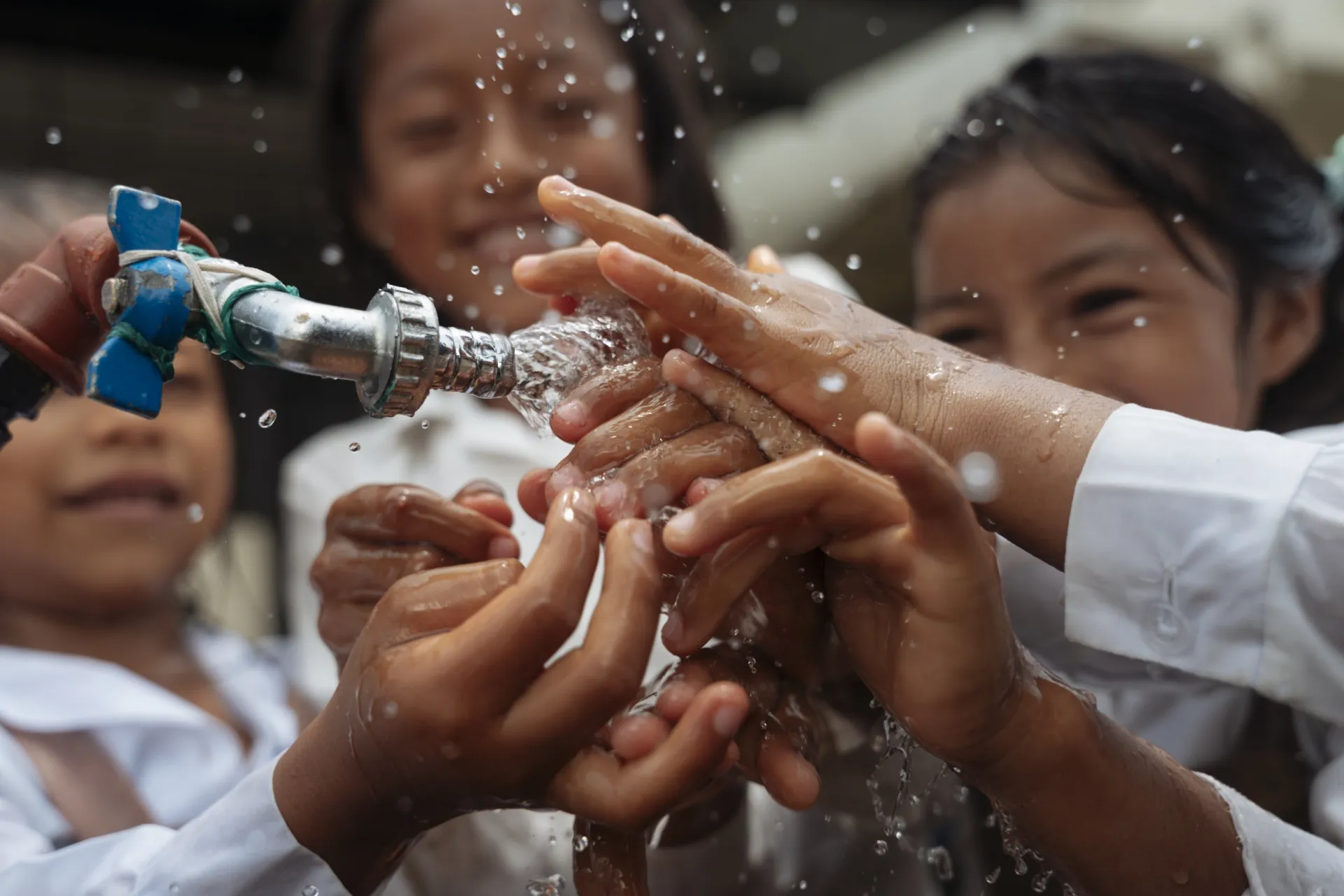 Children washing hands together