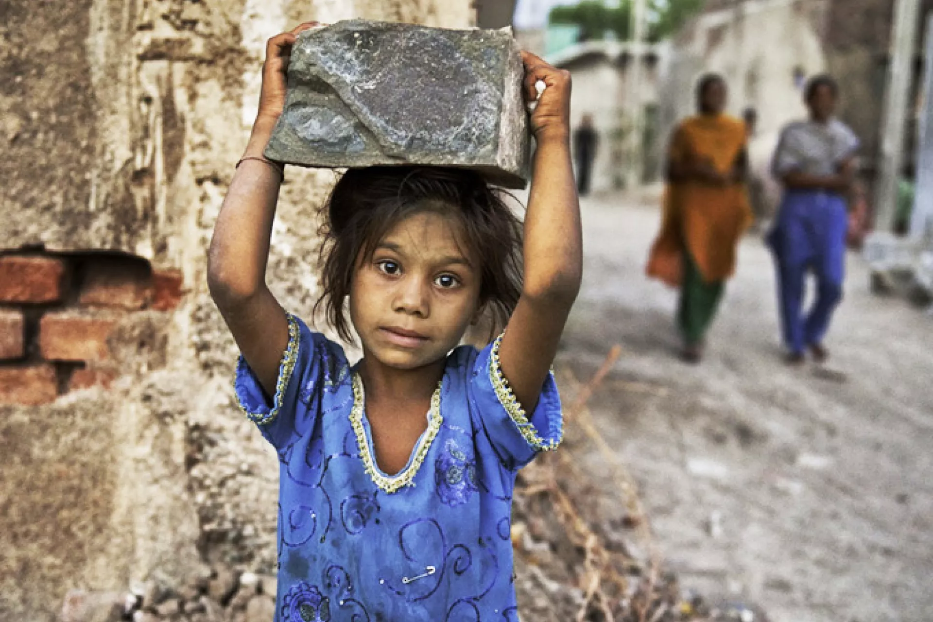 Girl in India works selling bricks