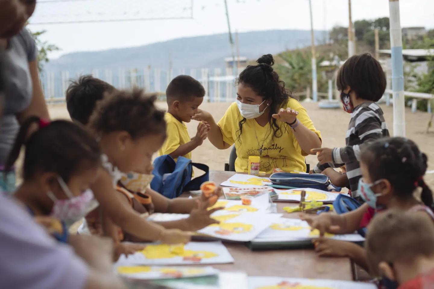 On 19 October 2020 in the Monte Sina&iacute; neighbourhood of Guayaquil, Ecuador, Denisse Toala (centre right, in mask), 17, leads a painting exercise for local children. Monte Sina&iacute; is one of the more economically disadvantaged neighbourhoods in the city. Since classes moved online at the onset of the COVID-19 pandemic, many children have fallen behind in their learning due to a lack of resources necessary for successful remote learning &ndash; 