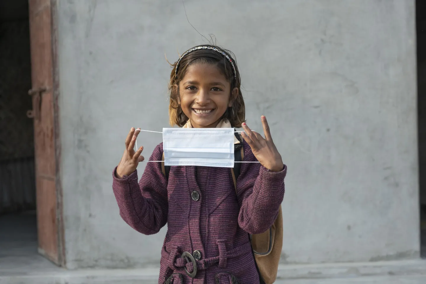Nirma (8) always wears her mask before stepping out during covid 19 pandemic. Location : Adarsh Dhunda Village, Barmer, Rajasthan, India.