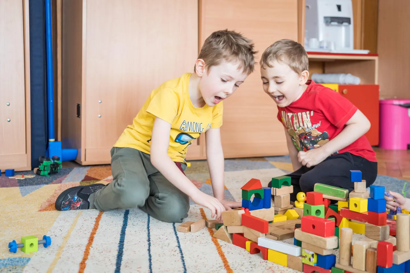 Two children play with toy building blocks on the floor of Kindergarten no.9 in Brasov, Romania, during the visit of President and CEO of UNICEF USA Michael Nyenhuis to the city.