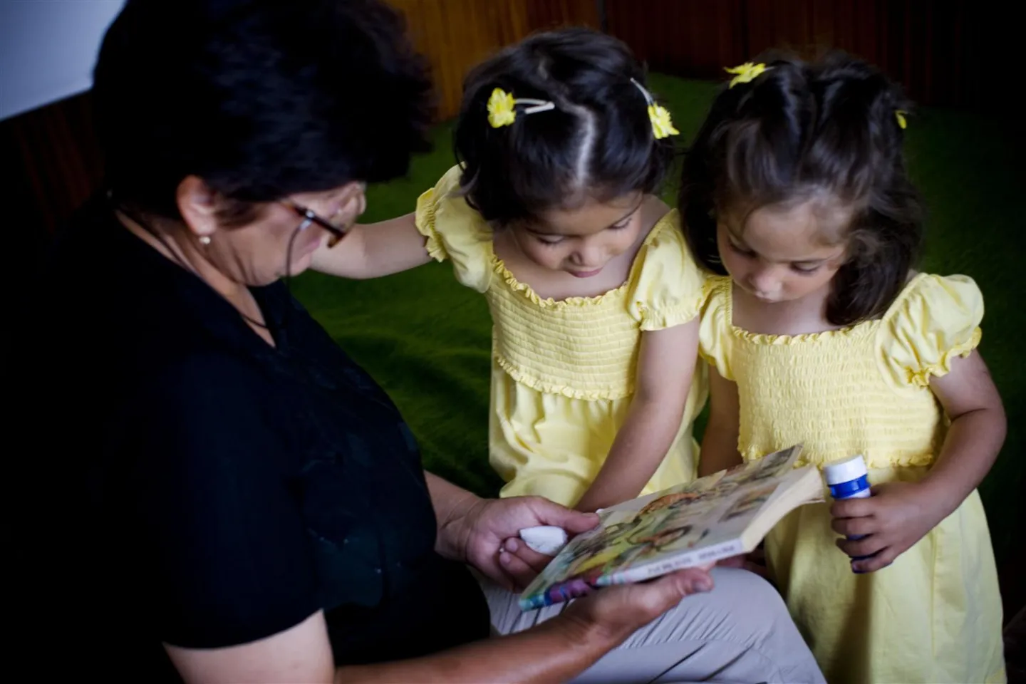 Nejymmia Yamen plays with her four-year-old twin foster daughters, Ivayla and Ivelina, at their home in Bulgaria.