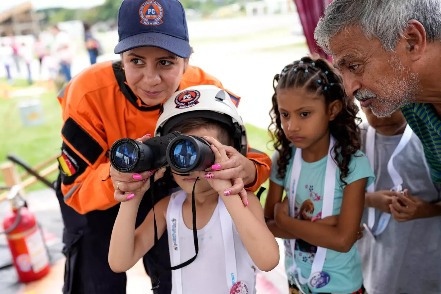 A boy plays with binoculars during Children's Rights Fair of UNICEF Venezuela, 