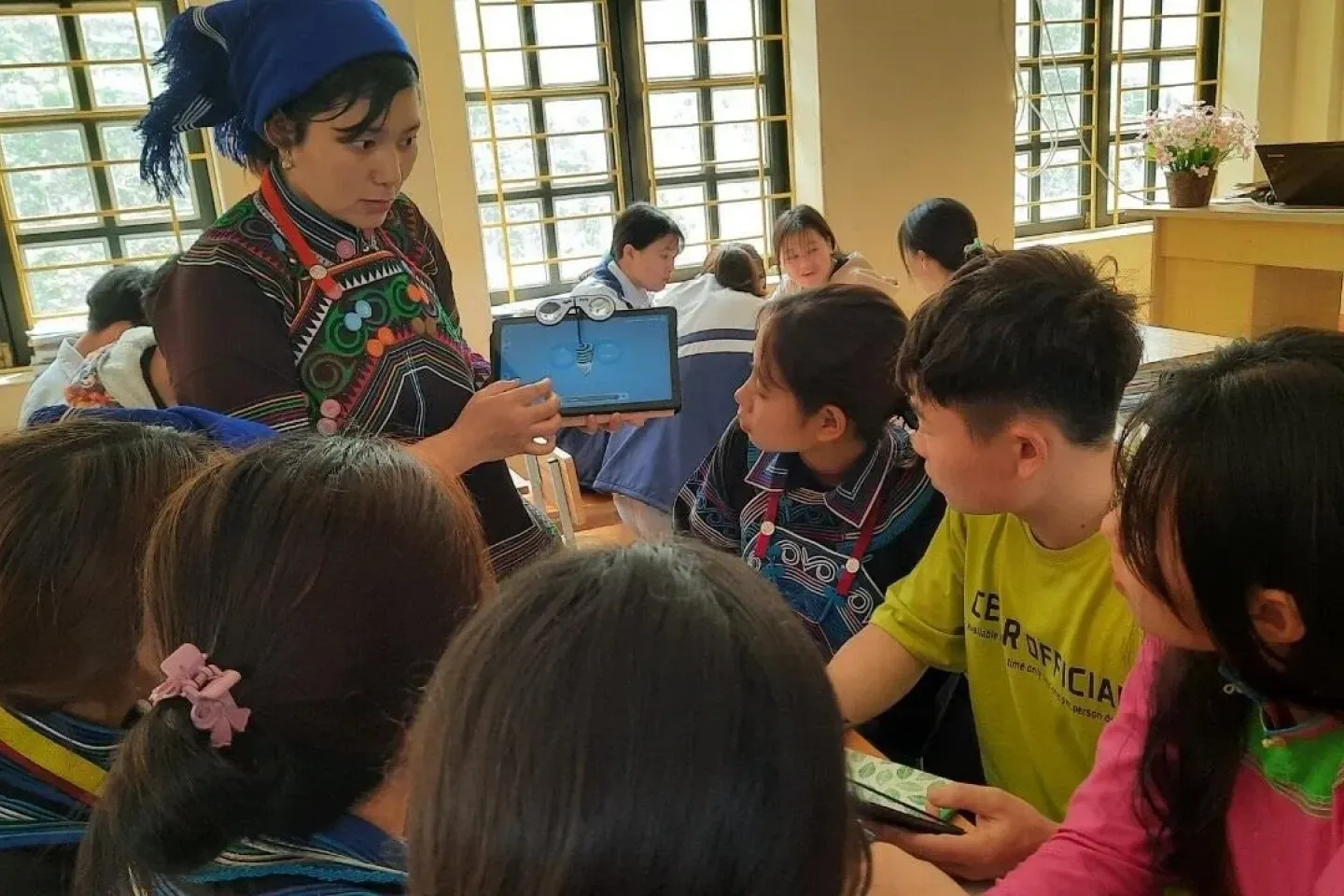 Ms. Trang Tho Phe, 33-year-old female teacher at Bat Xat Lower and Upper Secondary School, Lao Cai, Viet Nam.  Ms. Trang Tho Phe introduces her lesson to students using a tablet. Digital divide is still to be narrowed for students living in remote areas.