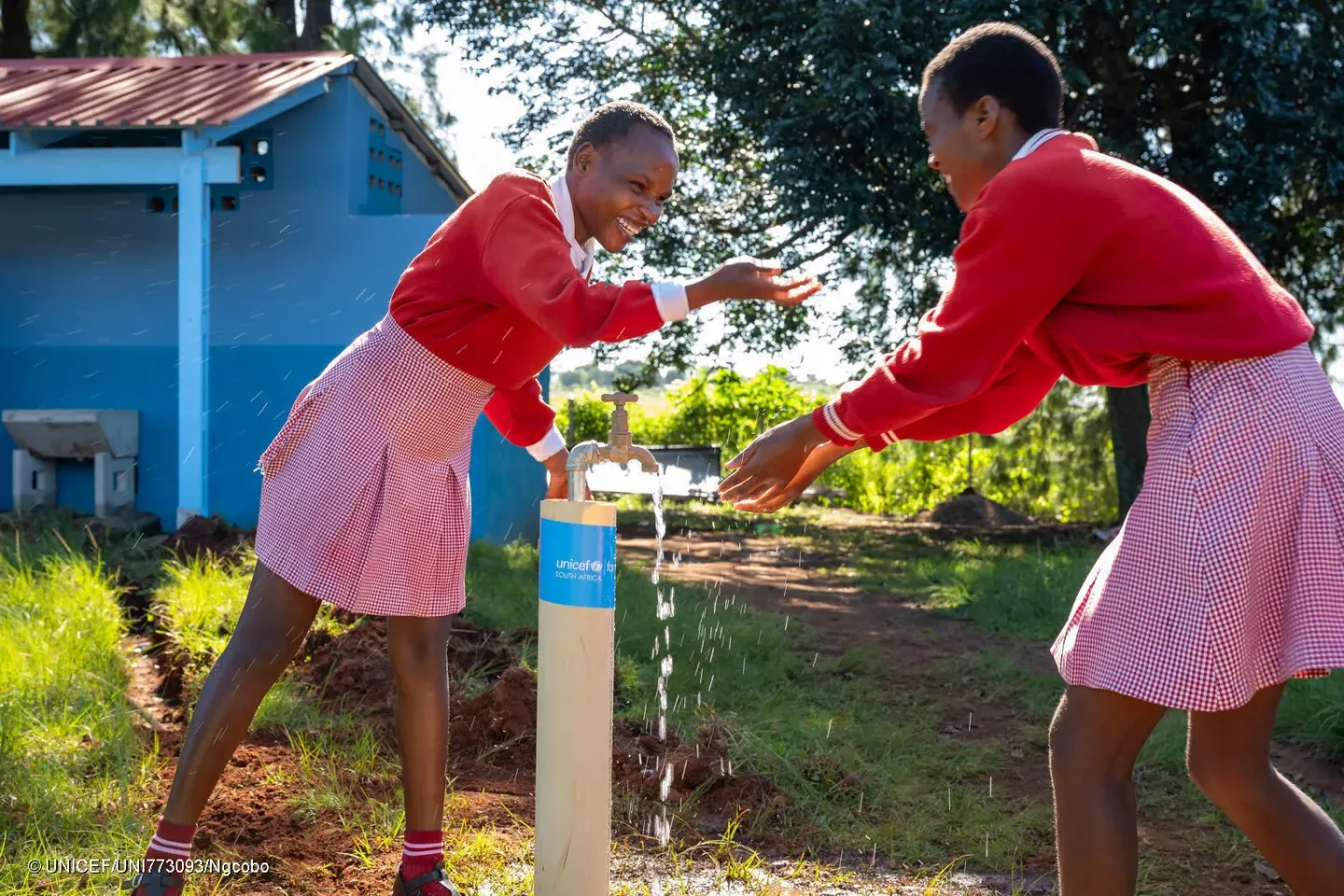 Students at Mabayana Secondary School in Ndwedwe, KwaZulu-Natal, drink and play at their newly built taps, installed by UNICEF in partnership with the government of Japan and the Clinton Health Access Initiative.