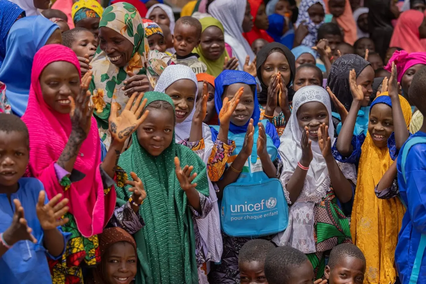 Children welcome UNICEF Deputy Executive Director for Humanitarian Action and Supply Operations, Ted Chaiban