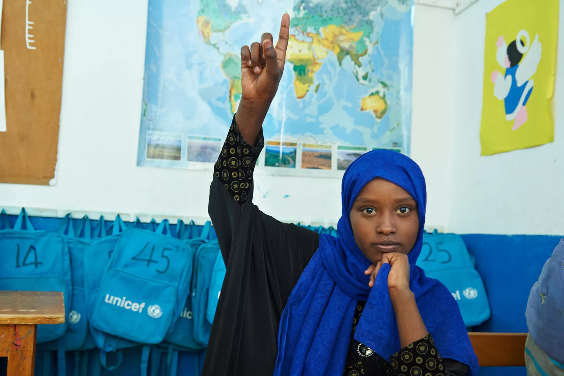 A girl child raises her hands to ask her teacher's question in a school for disadvantaged children at the LEC of Ali-Sabbieh in Djibouti.