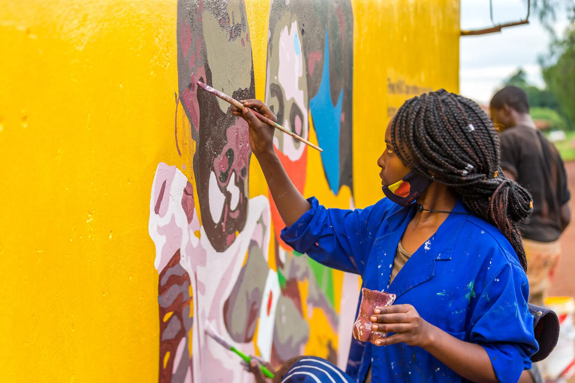 A female artist paints the ZIRP Murals in Chipinge, Zimabwe on 15 December 2020.