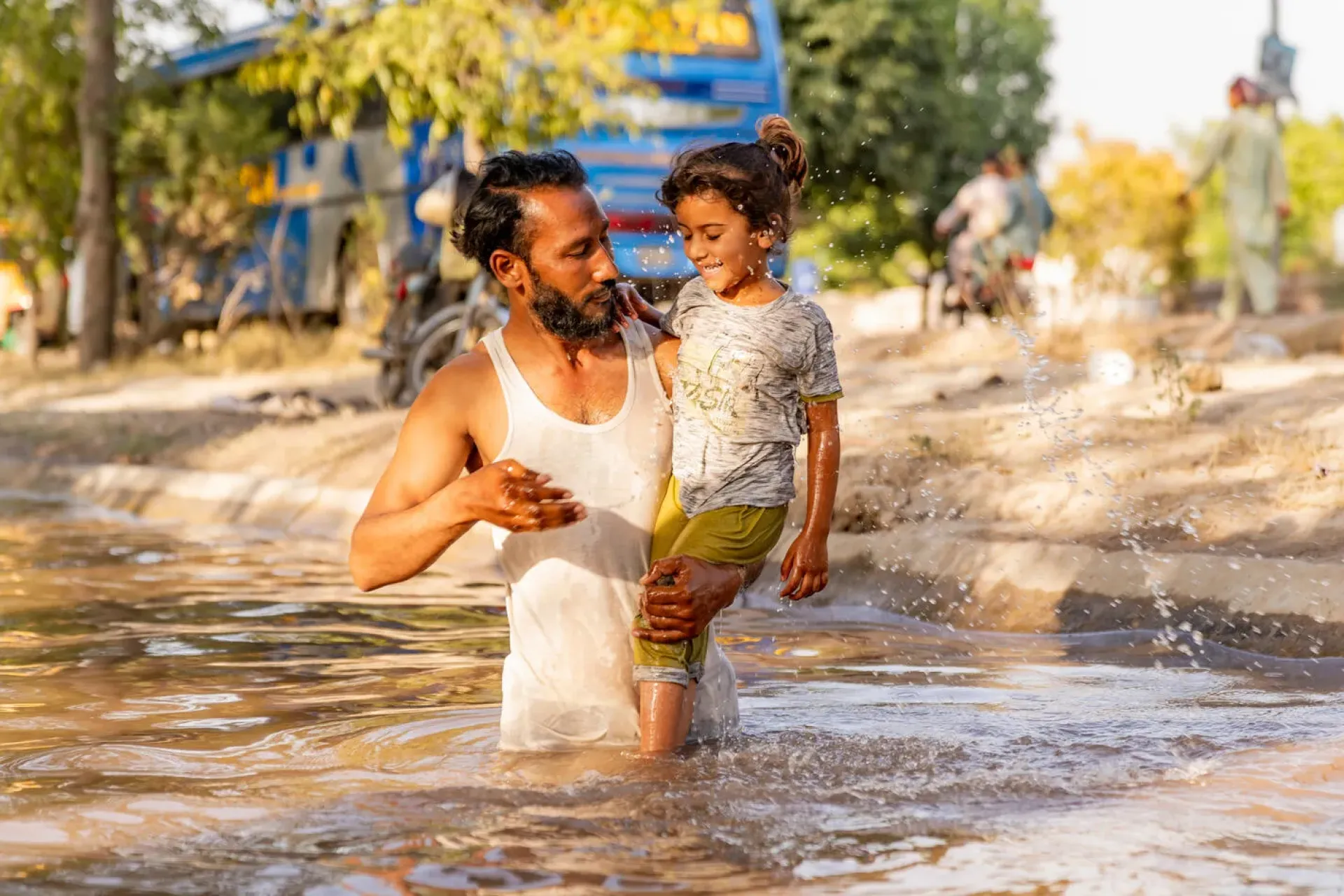 On 28 May 2024, it was a scorching 47&deg;C day in Faisalabad, Punjab. Muhammed Arshad shares a refreshing moment with his 4-year-old daughter, Ayesha, as they splash in the canal, finding relief from the heat. The unnaturally intense heatwave across Pakistan has been carrying on for a week or so.  Heat and soaring temperatures are not new to South Asia, but climate change is causing more frequent, severe, and longer heat waves, putting children and pregnant mothers at higher risk.
