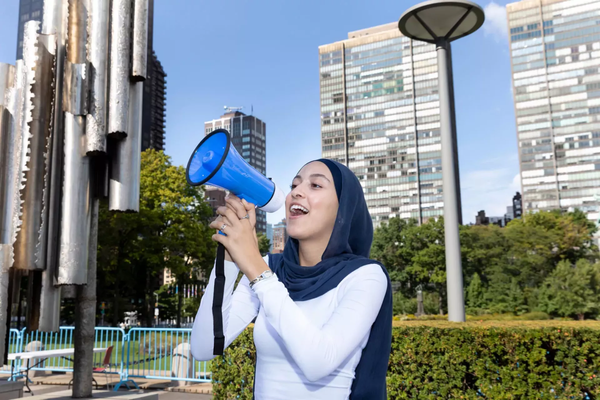 At United Nations Headquarters in New York, UNICEF Youth Advocate Sofia Dasser, Education Advocate from the United States, uses a megaphone as a prop during a portrait session at the General Assembly visitor&rsquo;s entrance plaza while attending the opening session of the Summit of the Future Action Days.
