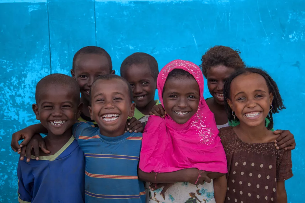 A group of happy children outside the Accelerated School Readiness (ASR) programme in Ethiopia