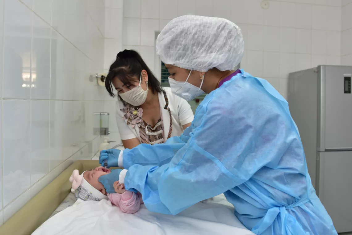 A doctor immunizes a baby