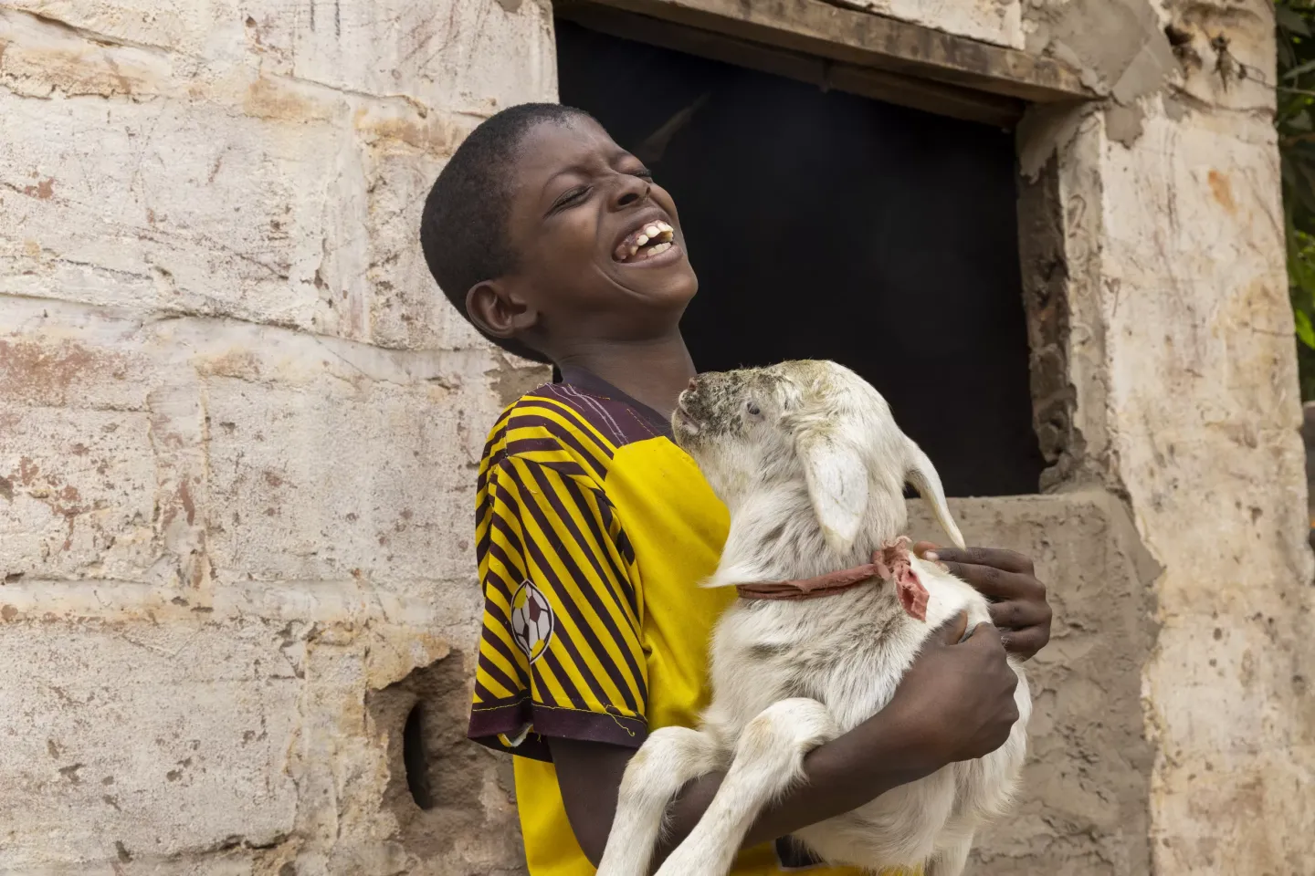 Abdourahman (10) holds a goat after a health worker visited their compound