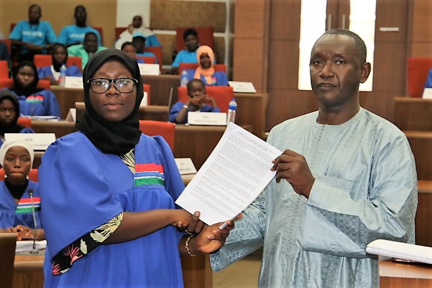 A child presents call to action paper to government representative