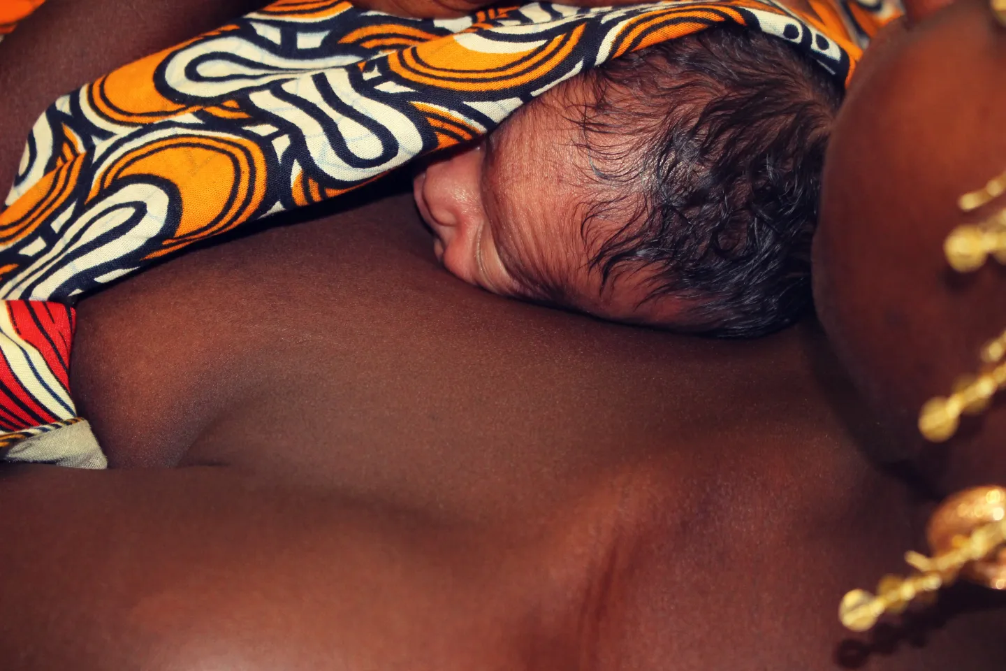 Baby tied to mother's chest as part of Kangaroo Mother Care 