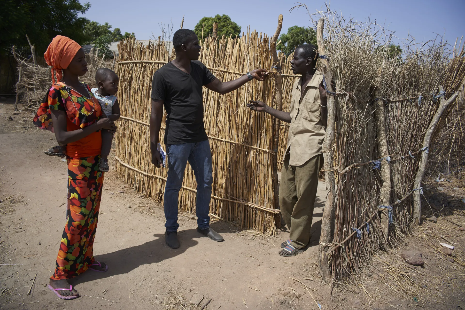 Community worker speaks to a family