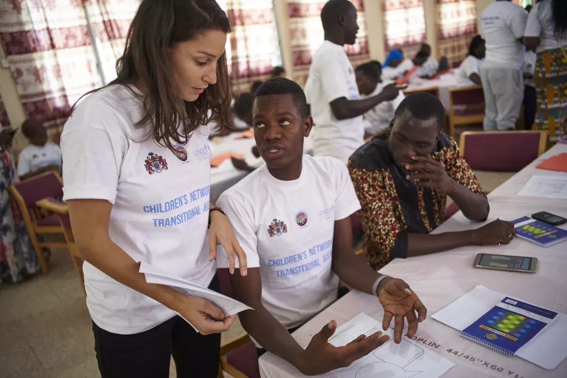 Member of children's network discussing with workshop facilitator