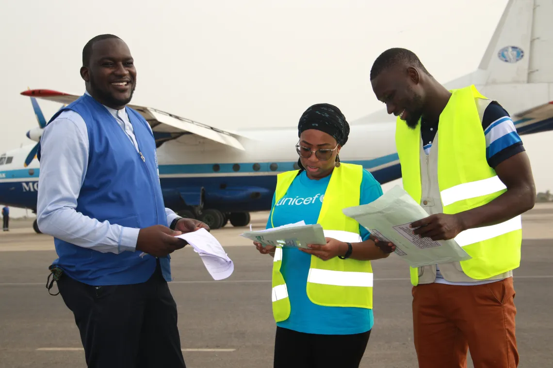 UNICEF and Ministry of Health staff receive a consignment of vaccines at the airport