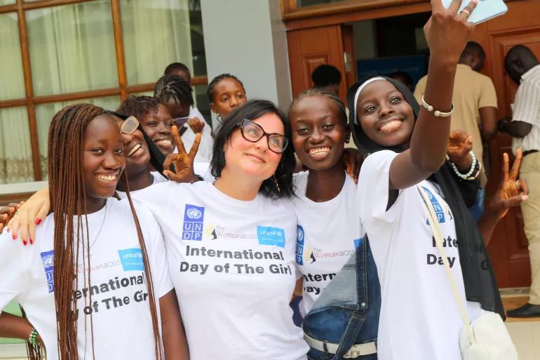 UNICEF Gambia Representative a.i poses with girls during International Day of the Girl celebrations.