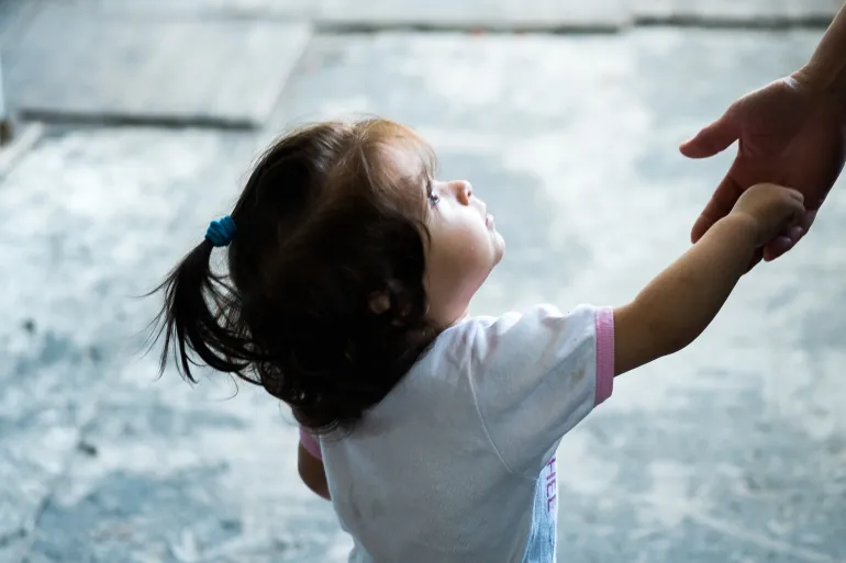 Little girl holding hand