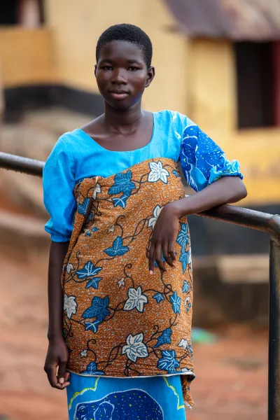 Christabel, 12, standing in front of her house 