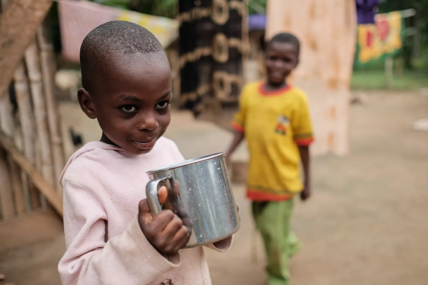 Latifa Abdul Latif drinking a cup of water at her home in the community of Ahmansu Junction in the Volta Region of Ghana on 17 August 2016.