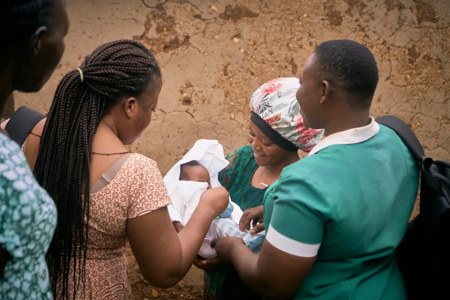 Azumah Bugre smiles as she holds her newborn outside her home in Gundoug/Mihiiboug, Upper East Region, Ghana.