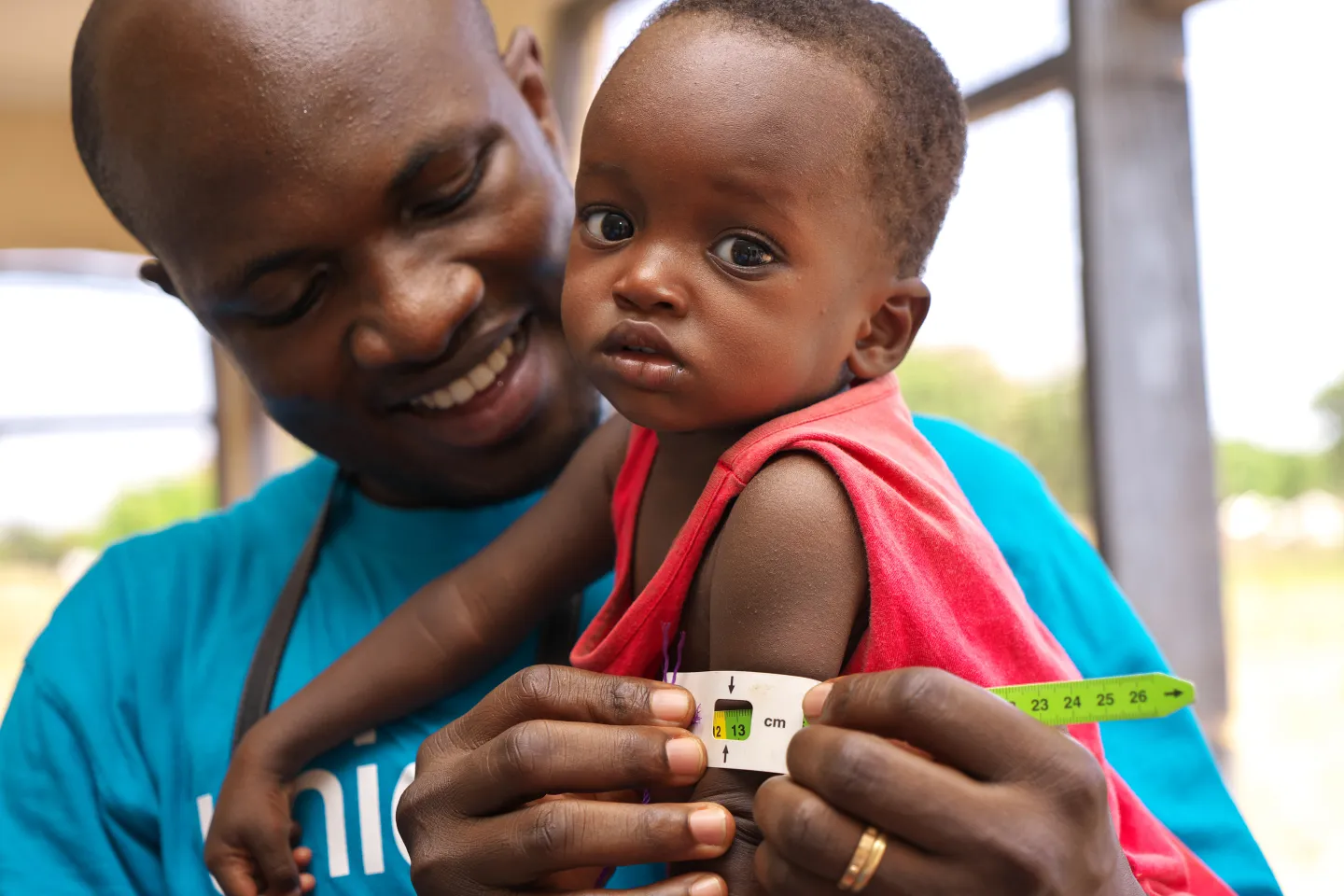  Health Worker holding toddler 