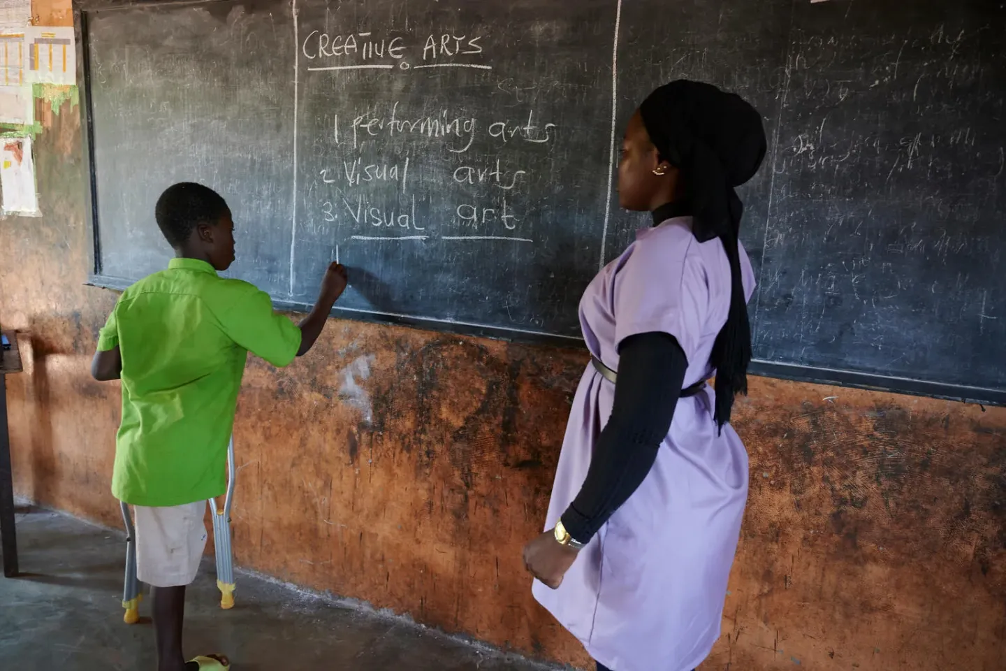Safiwu Haruna, 12, writes on a blackboard in an inclusive arts class at WaleWale MA Primary A School in WaleWale, North East Region, Ghana.