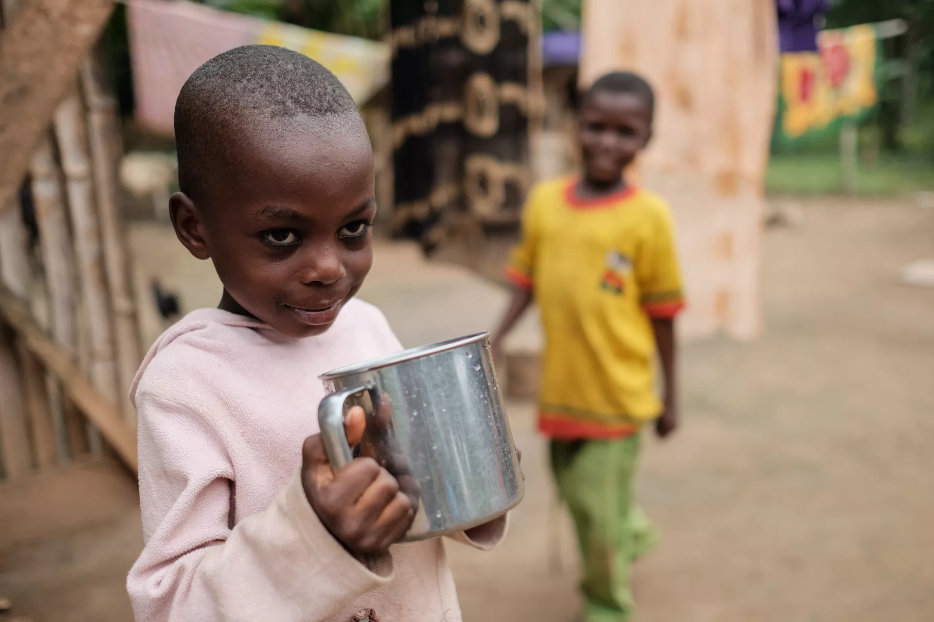 Latifa Abdul Latif drinking a cup of water at her home in the community of Ahmansu Junction in the Volta Region of Ghana on 17 August 2016.