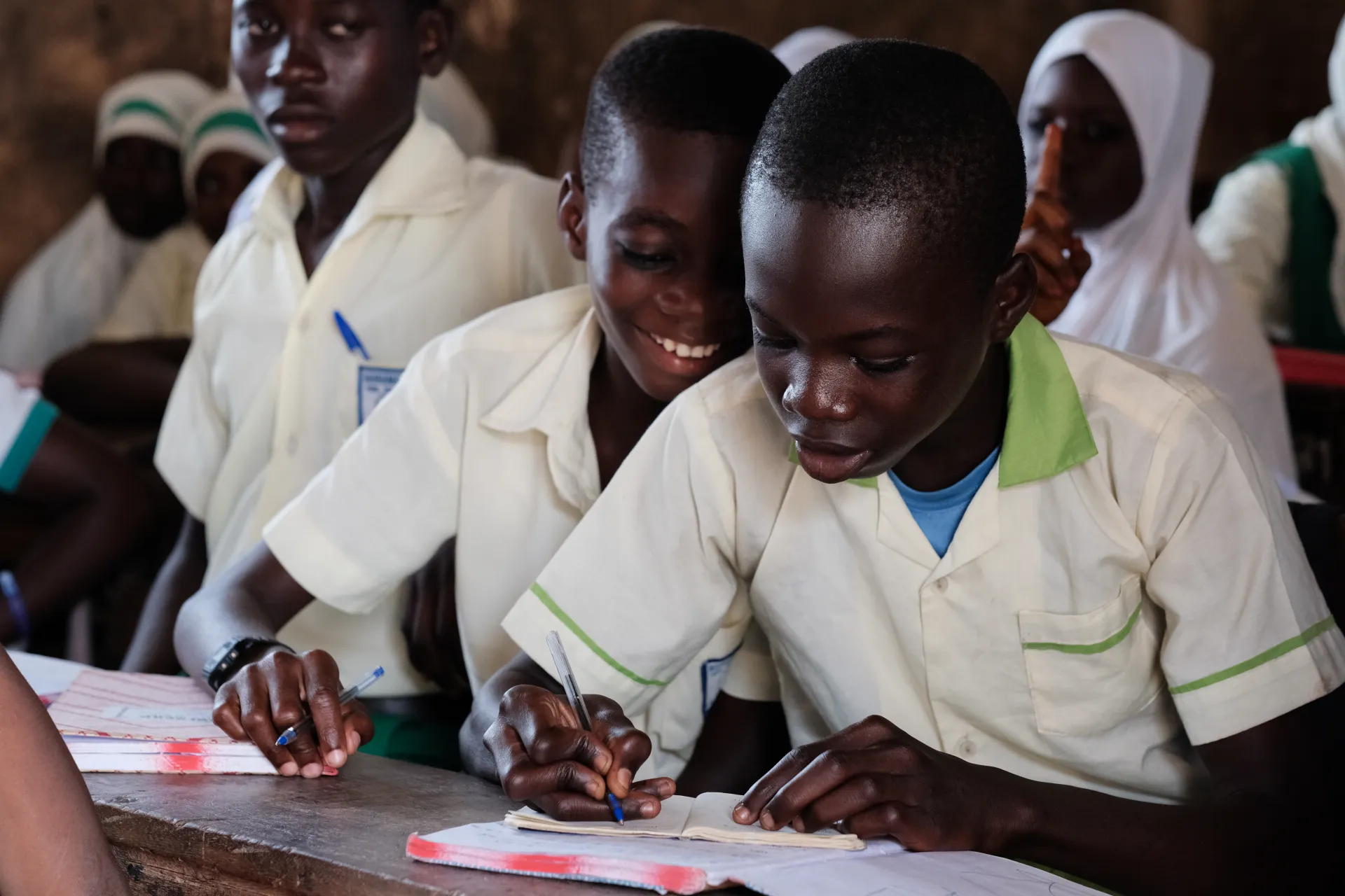 Two boys reading together in class